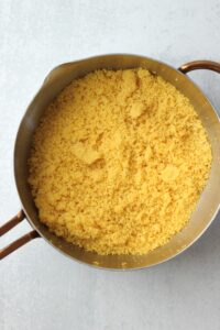 The cooked couscous in a pot.