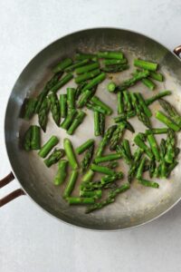 The cooked asparagus in a pan.