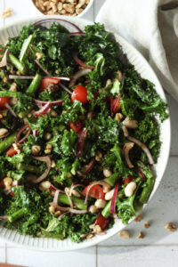 The dressing was poured onto the salad and it has been tossed.