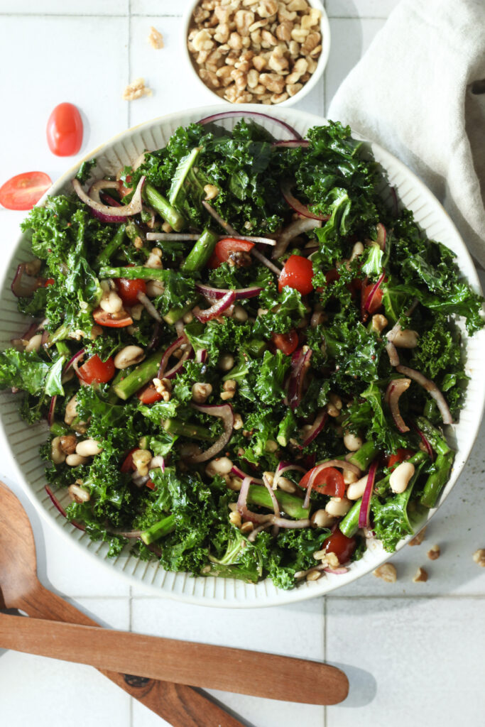 The salad has been tossed in a large salad bowl and is ready to enjoy.