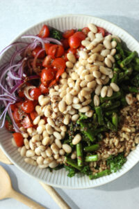 All of the salad ingredients have been added to a large bowl.