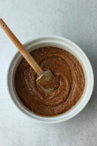 The wet ingredients have been mixed in a large white bowl.