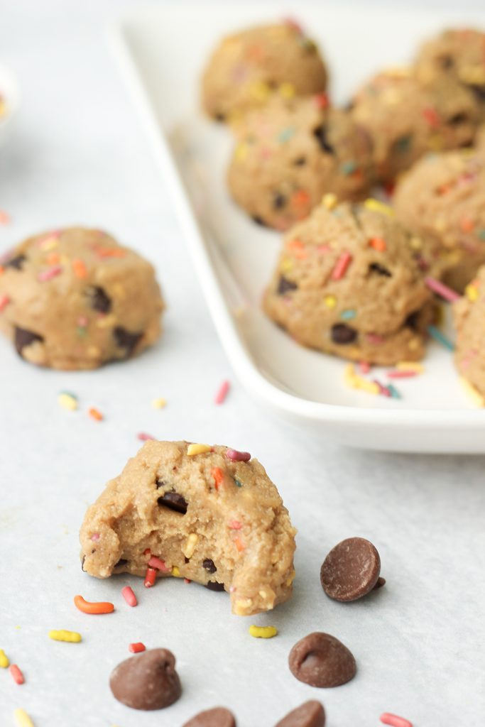 A bite out of one vegan cookie dough protein ball.