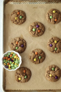 Pressing the chocolate candies into the tops of each cookie.