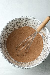 The dry ingredients mixed in a large speckled bowl.