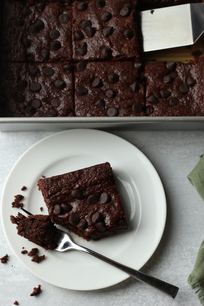 A slice of the brownies on a small white plate.