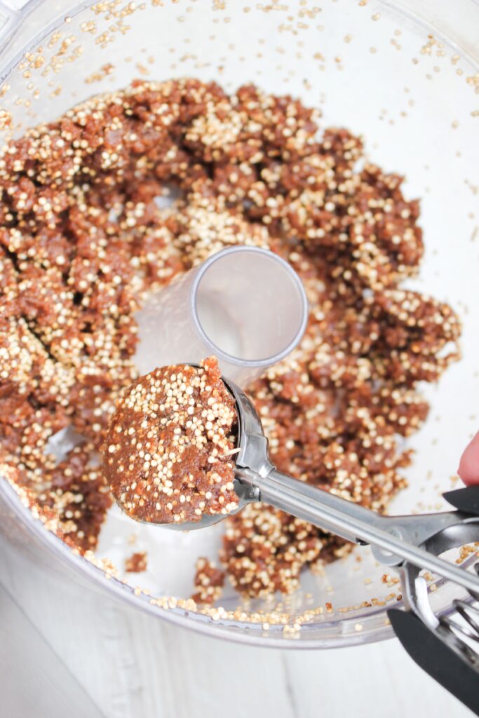 A scoop of the date mixture in a cookie scoop.