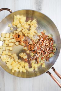 Cooking the topping ingredients in a pan over the stove.