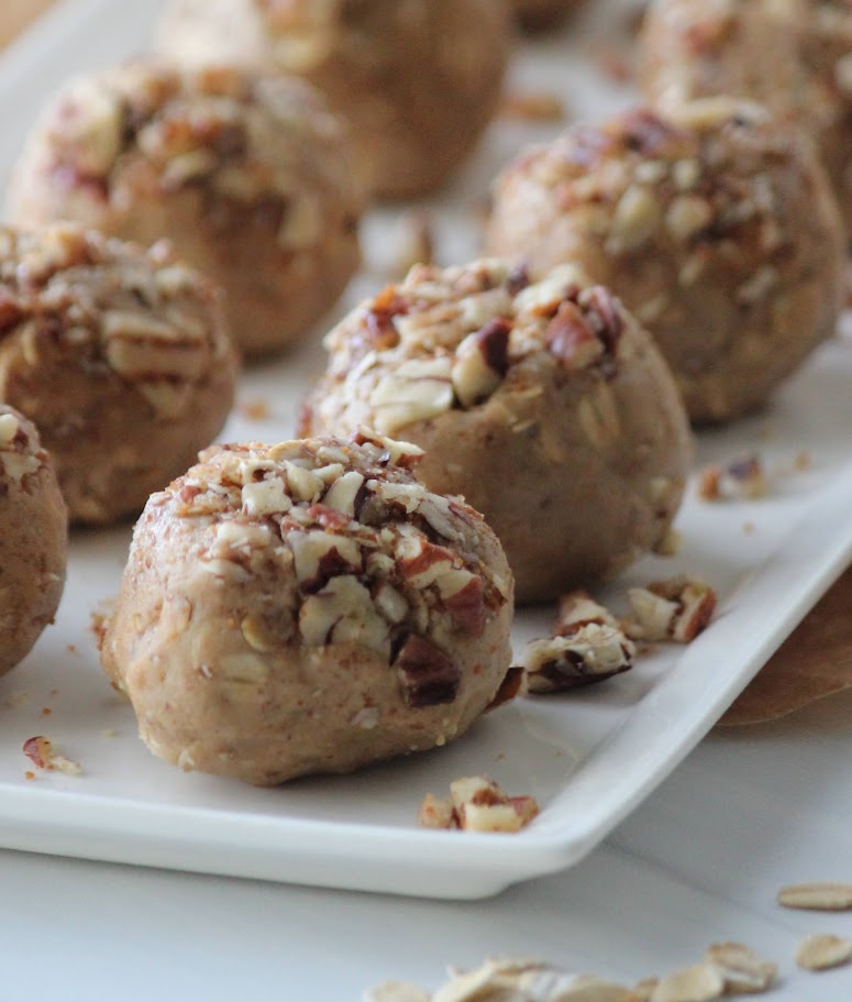 An up-close picture of the pecan protein balls on a white plate.