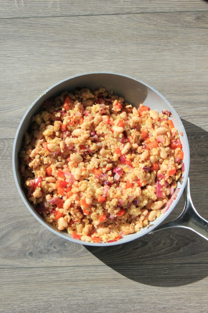 Stuffed Acorn Squash mixture cooked in a frying pan.