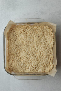 The brown cereal mixture has been pressed into the pan.