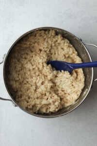 The brown rice cereal has been mixed into the melted marshmallows.
