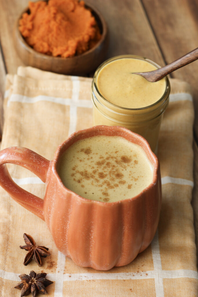 Pumpkin spice latte in an orange pumpkin coffee mug.