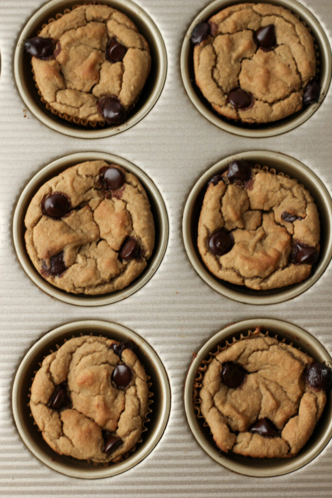 The muffins have just come out of the oven in a muffin tin.
