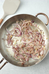 The onions have been sauteed in a pan.