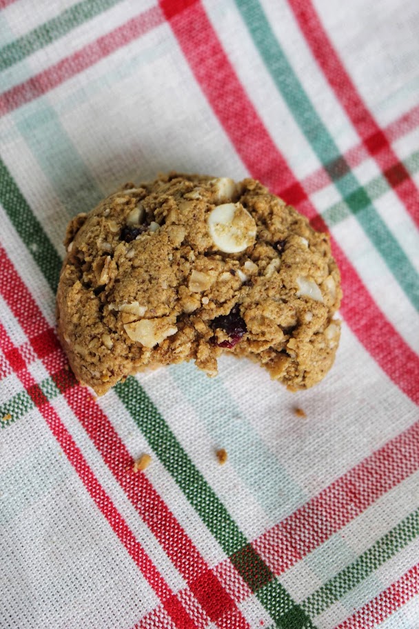 A bite out of a white chocolate cranberry cookies.