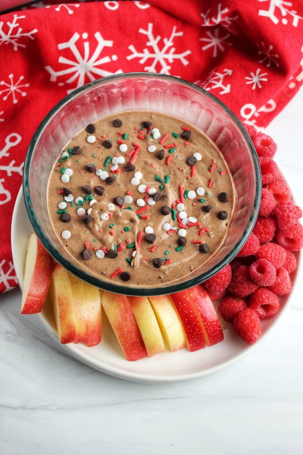 High protein chocolate fruit dip served with apple slices and raspberries.