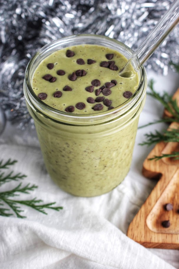 Holiday White Peppermint Protein Smoothie is ready to drink with a glass straw.