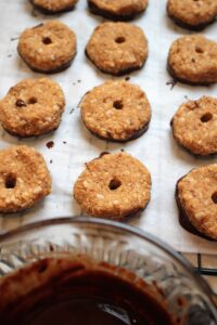 Healthy Vegan Copycat Girl Scout Caramel DeLites have been dipped into chocolate.