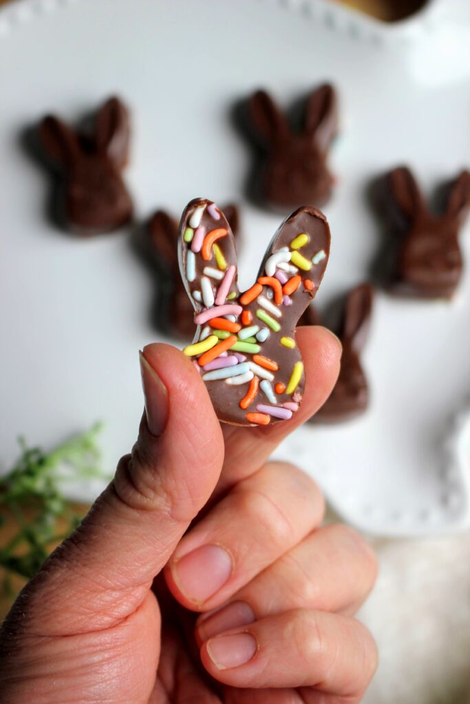 I am holding a Homemade Peanut Butter Chocolates for Easter.