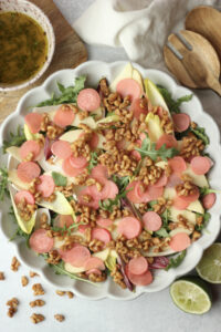 All of the salad ingredients have been added to a large salad bowl.