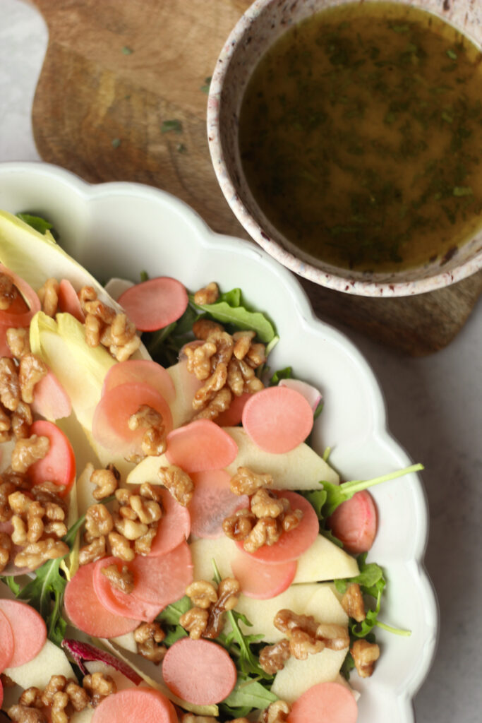 The salad dressing is in a bowl and is ready to be poured.