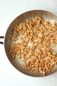 The walnuts have been cooked in a pan with maple syrup and vegan butter.
