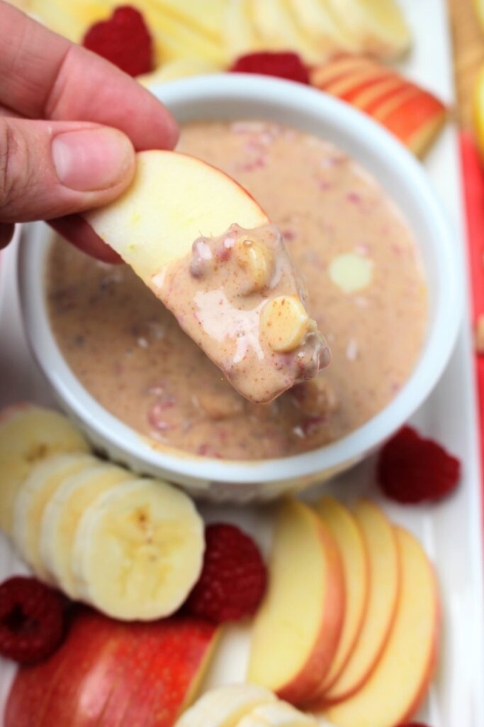 Dipping an apple slice into this fruit dip.