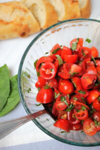 The bowl of bruschetta is mixed up and ready to go.