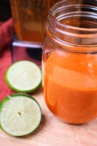 The dressing is in a small clear mason jar.