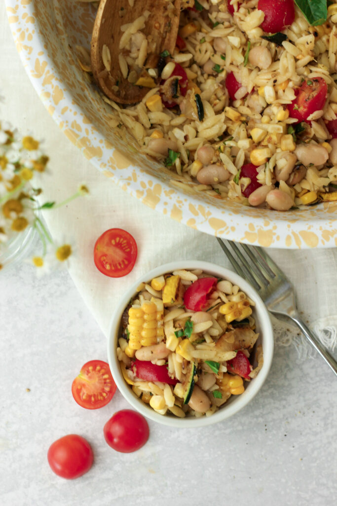 The orzo salad has been served and is ready to eat.