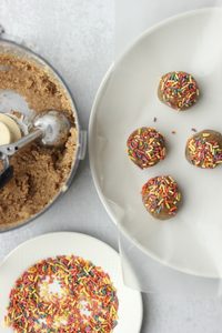 The dough has been scooped with a cookie scoop and dipped into sprinkles.