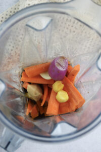 All of the ingredients in the bowl of a blender.