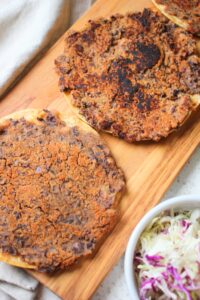 The fried tortillas are plated and ready to add toppings.