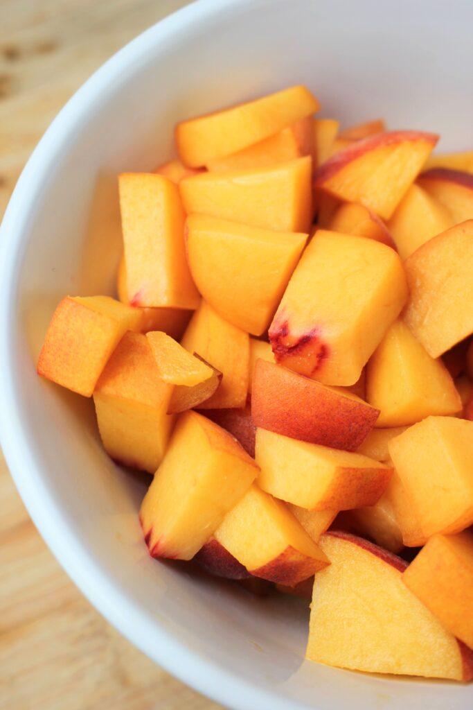 A bowl of fresh sliced peaches.