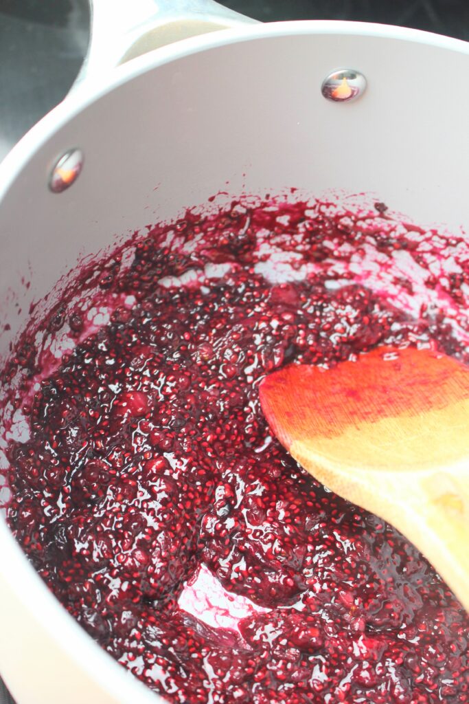 Cooking frozen berries in a sauce pan.