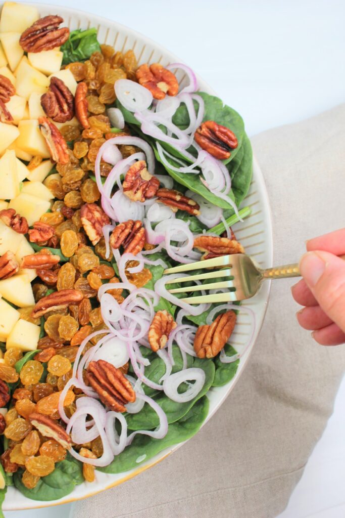 Using a fork to grab a bite of this fall salad.