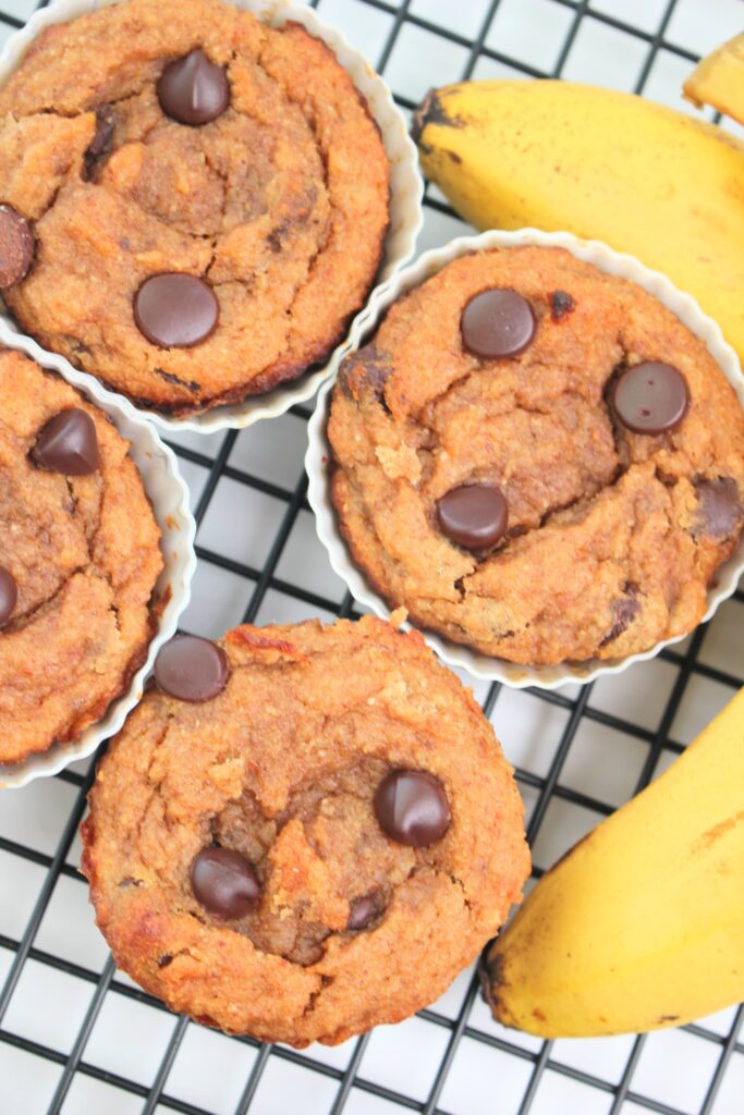 An up close picture of 4 one-bowl banana coconut muffins.