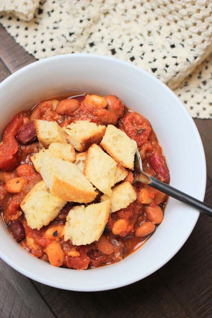 The vegan pumpkin chili served in a bowl with croutons on top.