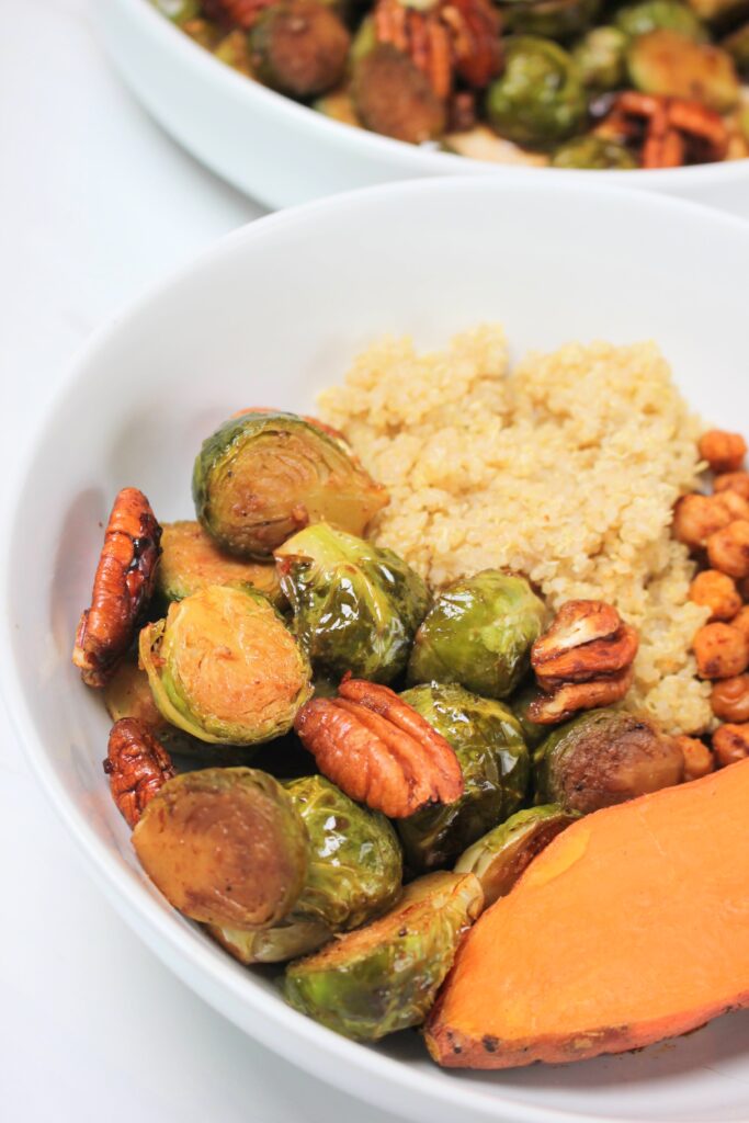 Roasted brussels sprouts paired with quinoa, sweet potato, and roasted chickpeas.