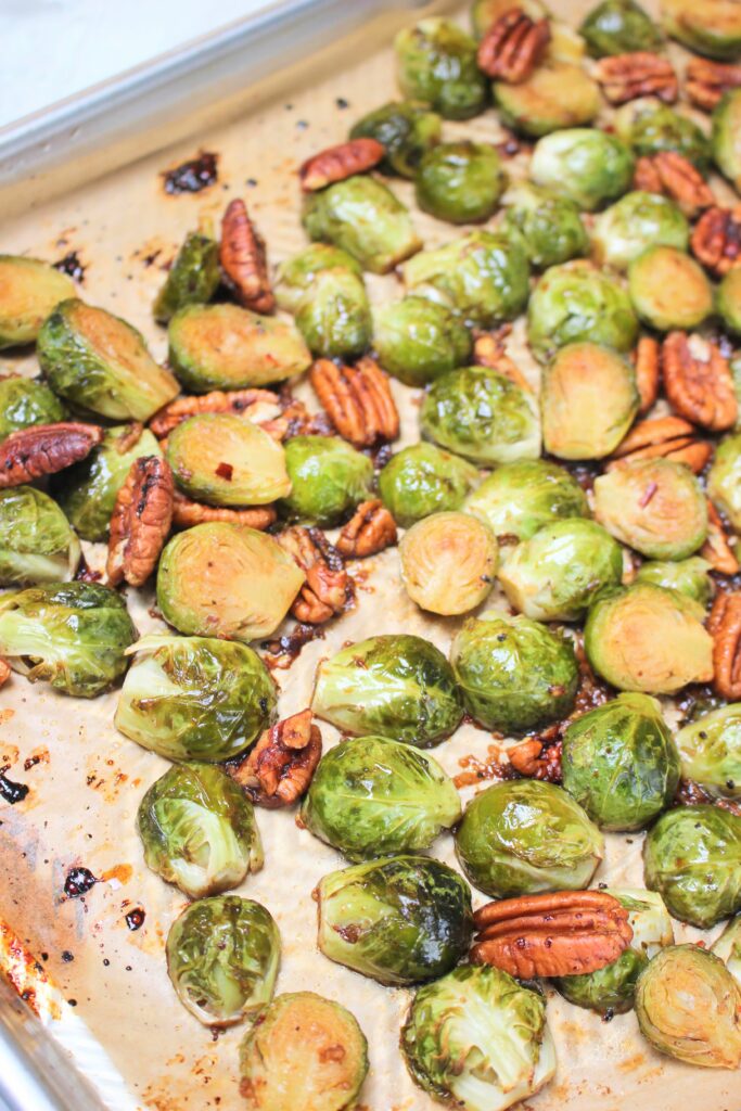 The brussels sprouts are hot on a pan and just came out of the oven.