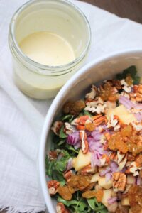 The dressing is in a mason jar and is ready to pour onto the salad.