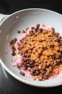 The black bean mixture is frying in the pan.