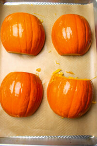 The pumpkin halves are on the pan and ready to be roasted.