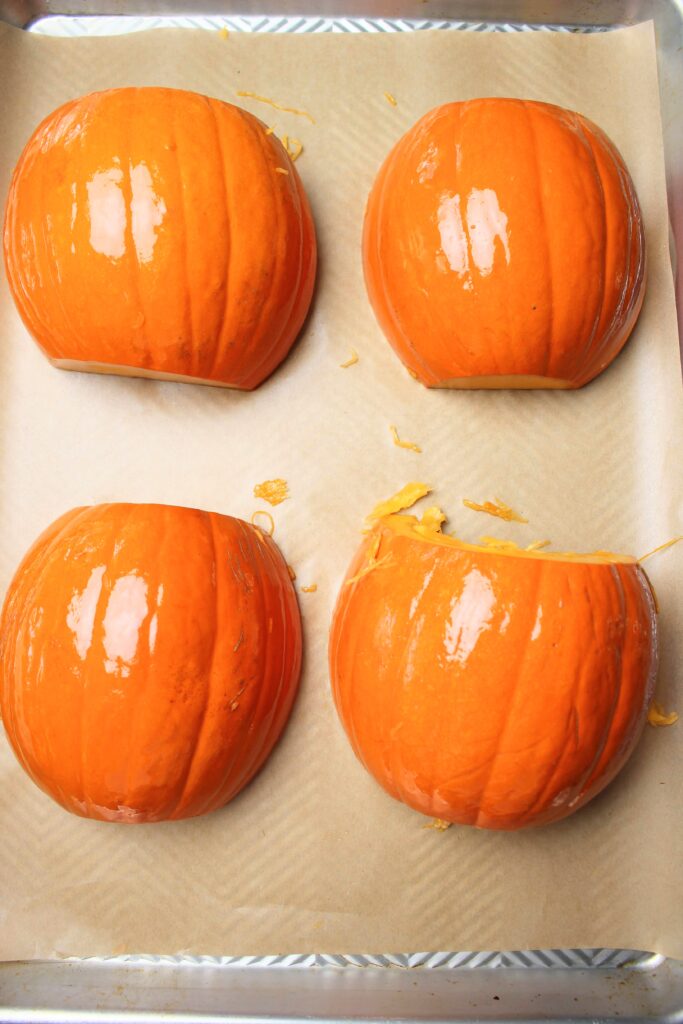 The pumpkin halves are oiled and ready to be cooked in the oven.