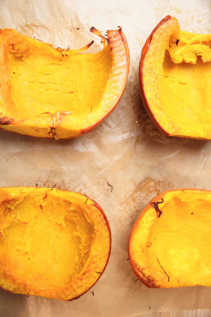 The pumpkin halves are hot and roasted on a pan.