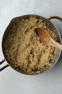 The quinoa is in a pan and is done cooking.