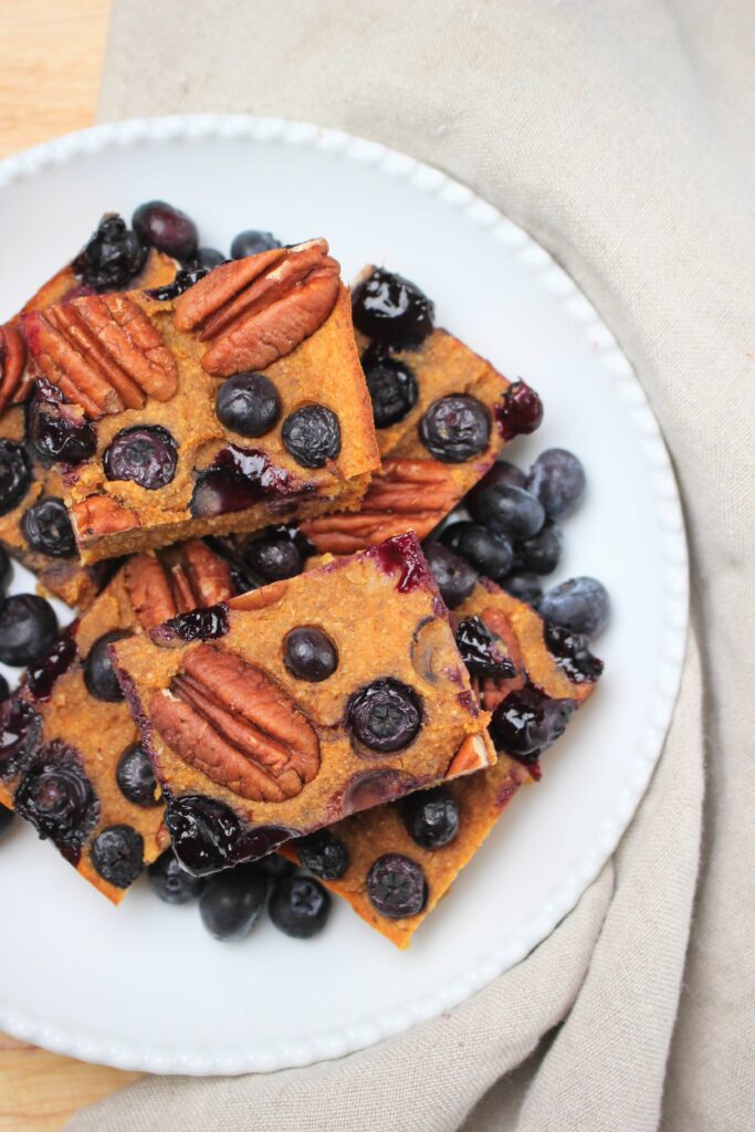 A plate up cut up blueberry breakfast bars.