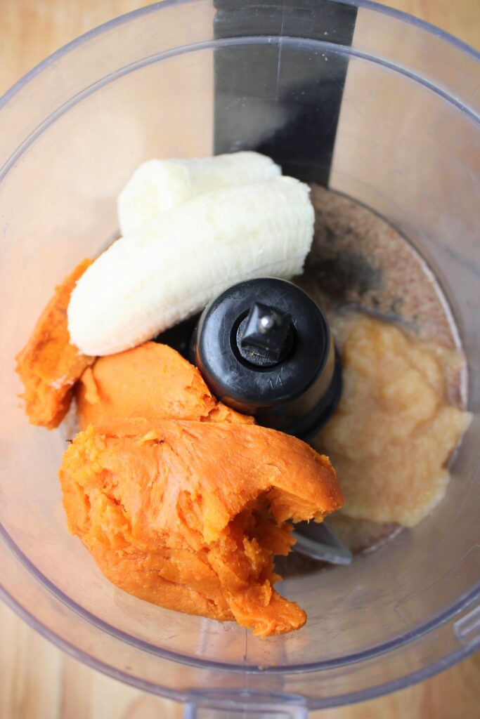 The wet ingredients in the base of the food processor. 
