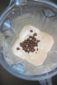The coffee beans poured into the blender and ready to blend.